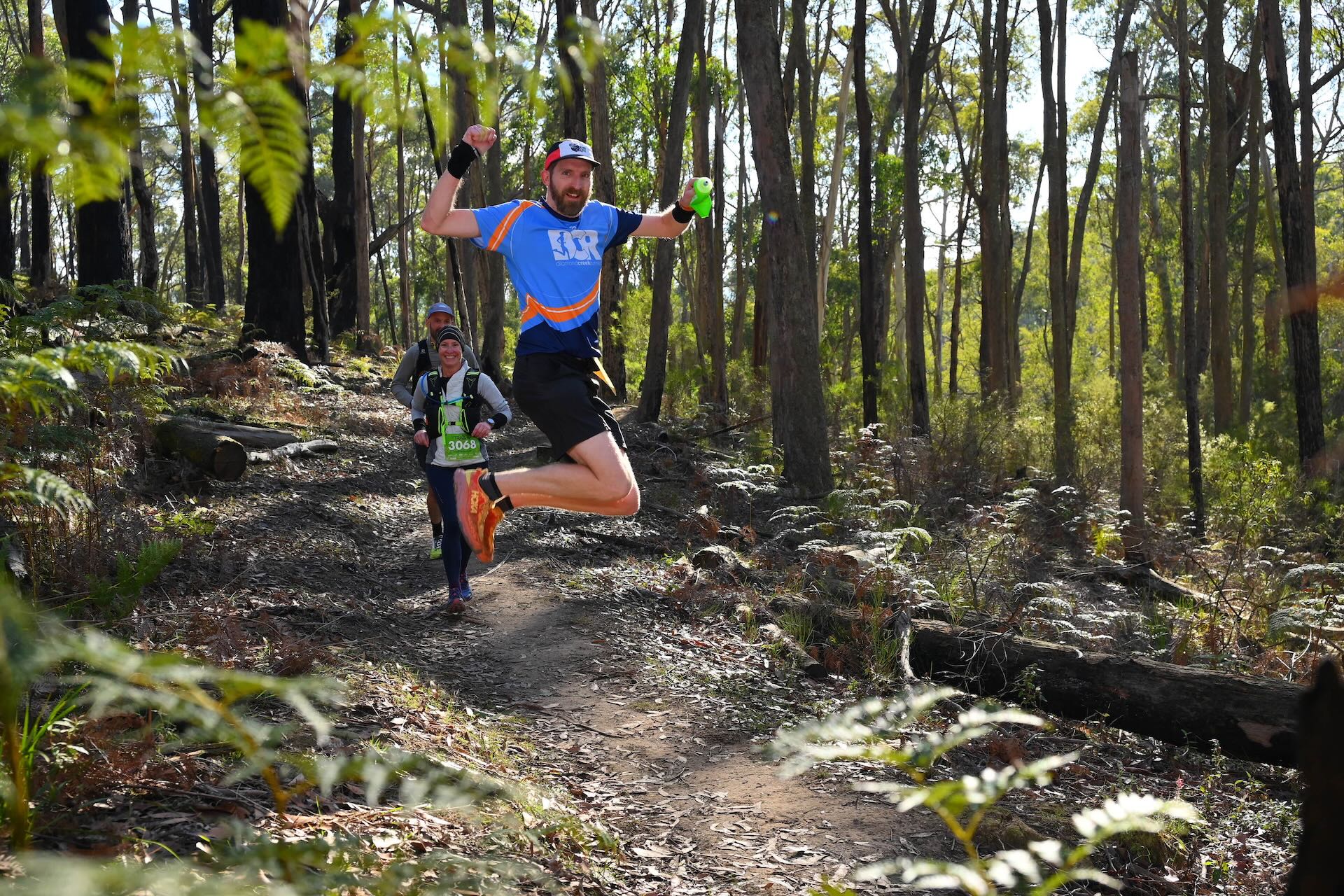 A photo of Ross Poulton jumping high during a trail race at Blackwood, Victoria, in June 2025.