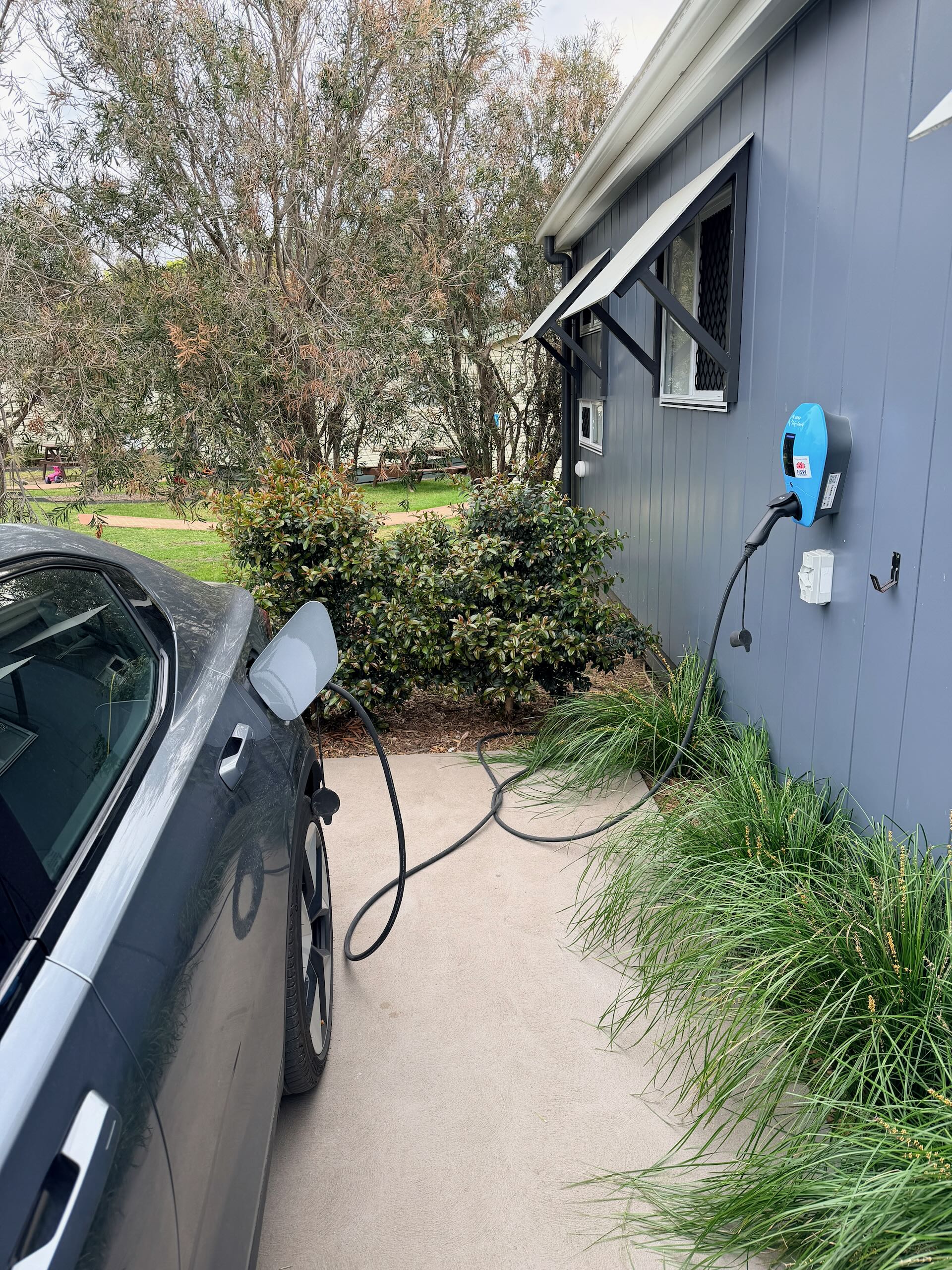 My Polestar 2 using the free fast charger at the NRMA Merimbula Holiday Park (only some cabins have EV chargers, and they can only be used by those staying in the attached cabin)